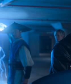 Johnny Cage (Karl Urban) stands in the extreme foreground of a shot as Raiden (Tadanobu Asano) lights up the area with lightning in Mortal Kombat II
